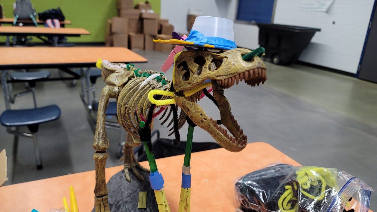 a dinosaur fossil with makeshift arms attached